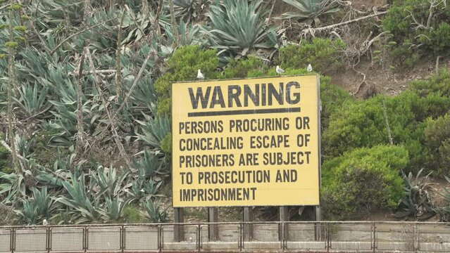 This video shows a close up view of a prisoner concealment warning sign.