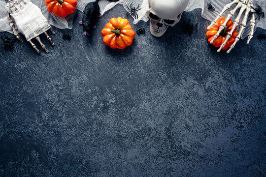 Halloween Decorations, Pumpkins, Skull, Zombie Hands Wrapped Bandage On Grave Stone. Flat Lay, Top View.