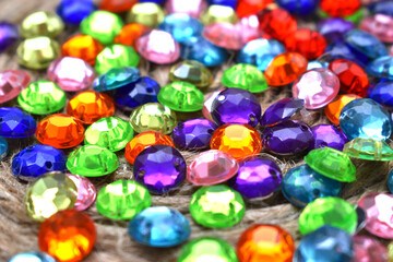 Fototapeta na wymiar a pile of small colored gems placed on a string binder
