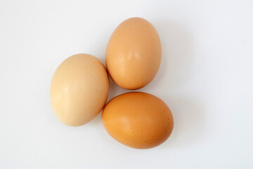 Fresh homemade eggs on white table