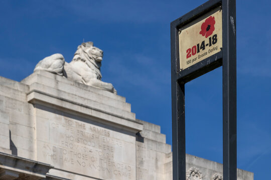 YPRES, BELGIUM - AUGUST 10, 2022:  Large stone lion on top of the Menin Gate Memorial with 100 year anniversary of WW1 sign