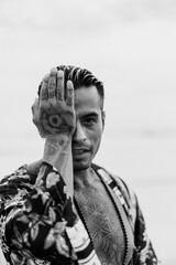 Emotional portrait of a handsome mexican tattooed man.