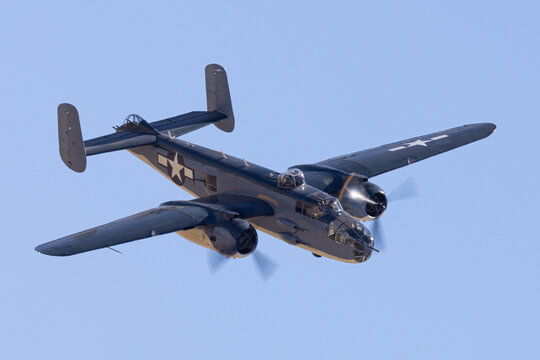 Close view of a WWII era bomber (B-25 Mitchell) approaching in beautiful light 