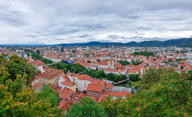 Fototapeta na wymiar Beautiful view over the old city center of Graz, with Mariahilfer church and historic buildings, in Styria region, Austria