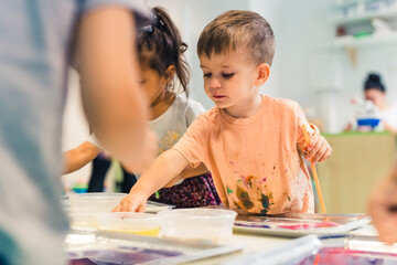 Fototapeta premium let's paint together, kids in the kindergarten. High quality photo