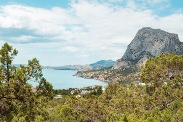 A scenic view of beach and coastal mountain against a clear blue sky in Senja, Norway. High quality photo