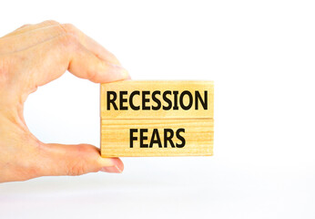 Recession fears symbol. Concept words Recession fears on wooden blocks on a beautiful white table white background. Businessman hand. Business and recession fears concept. Copy space.