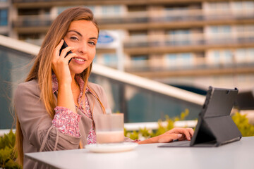 Commercial blonde woman having a coffee decaf for breakfast on a business call with a client