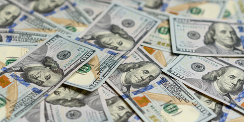 Money background. Texture of US dollars. Hundred dollar bills on the table close-up. Lots of American banknotes in cash. Profit, savings. Stack of dollars. Success, motivation, financial flows, wealth