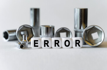 On a white background, a set with tools and white cubes with the inscription - error