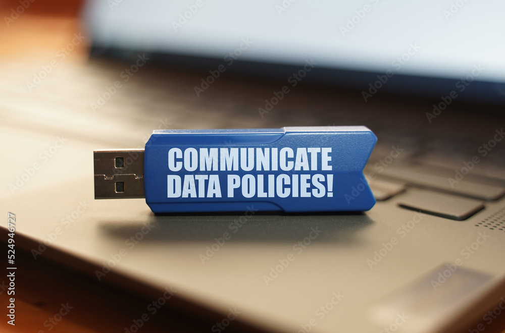 Poster on the laptop keyboard is a flash drive with the inscription - communicate data policies