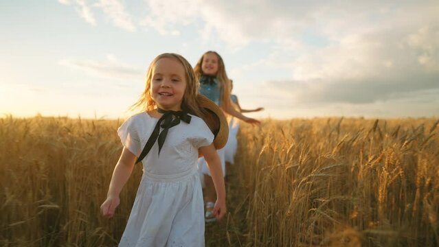 Three Little Sisters Are Running On Golden Rye Field And Having Fun, Rejoice And Happy Children