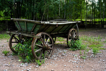 Fototapeta na wymiar An old wooden wagon. Vintage transport. Analogue of machines in antiquity