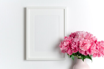 White frame mockup with peony flowers, mockup with copy space for artwork presentation