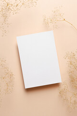 Invitation or greeting card mockup with dry gypsophila flowers