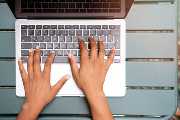 Top view of copywriter hand using laptop typing on keyboard, working freelance project at workplace