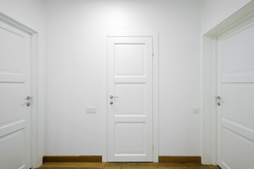 White interior doors in the white corridor