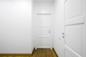 White interior doors in the white corridor