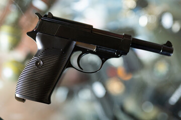 Replica of pistol over shocase in airsoft shop. Air weapon.