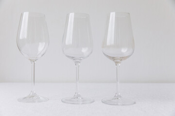 Thanksgiving set. Three empty wine glasses on a white table, mockup
