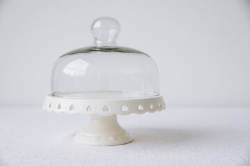 A cake stand on a covered white table, mock up