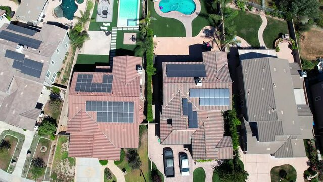 Solar panels on roof homes in suburb of Simi Valley, California - ascending aerial view