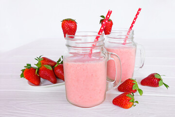Strawberry yogurt fruit juice smoothie pink colorful fruit juice milkshake blend beverage healthy high protein the taste yummy In glass drink episode morning on white wood background.