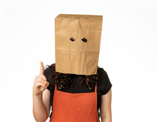 Young woman wearing paper bag over her head holding one finger up