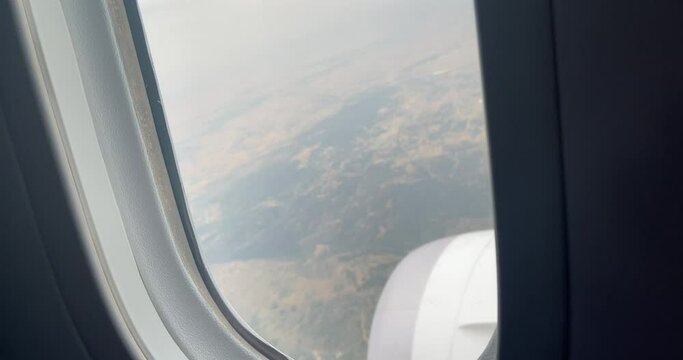 Shot from the cockpit of the city plane from above seen through the window.