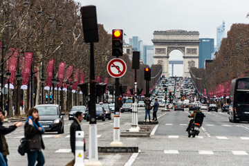 Naklejka na ściany i meble traffic in the city in the champs elysees paris with arch of triumph