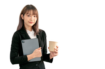 Picture of beautiful woman in black suit holding tablet and coffee cup posing over white background.