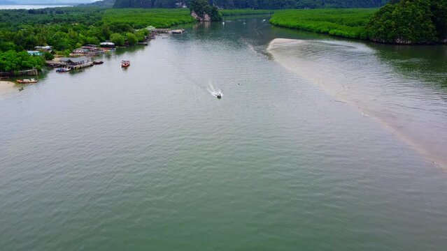 Aerial view from a drone of a white boat sailing on the blue sea Top view of a speedboat moving at high speed in the ocean