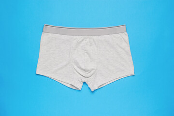 Light men's underpants on a light blue background. Minimal concept of men's underwear.