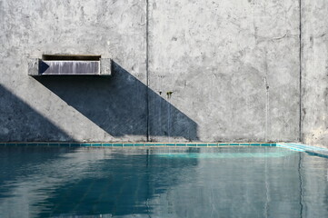 faucet of swimming pool on cement wall, construction industry