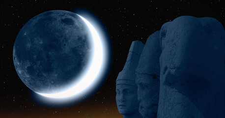 Statues on top of the Nemrut Mountain with crescent moon - Adiyaman, Turkey  