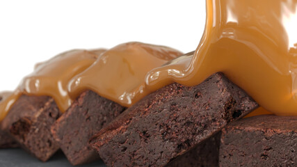 Closeup caramel Liquid Pouring on top Brownie cake. 3D render. Selective focus.