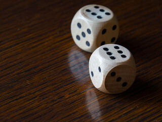 Playing with rolling dices on a wooden table