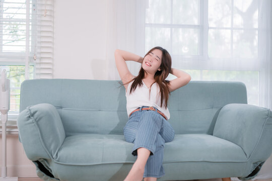 Asian woman sitting relaxation and comfortable her resting in weekend on the sofa in the living room at home