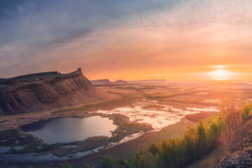 Panorama panoramic landscape nature mountains sunrise sunset of Chest butte or First Sunduk against blue sky. Sunduki mountain range from Devonian sandstone stone located in the valley of the Bely