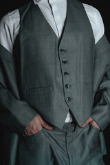 Chest of a man dressed in a suit. Business suit on a black background. High quality photo