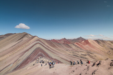 Amazing Mountainous Landscape In Peru.

photography of huaraz peru, with people with hiking clothes, lakes, mountains, colors, rainbow mountain.