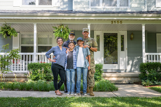 Air Force service member poses with family for group photo.