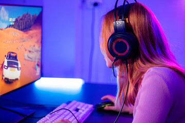 Young player woman wearing gaming headphones intend to do playing live stream games online at home,...