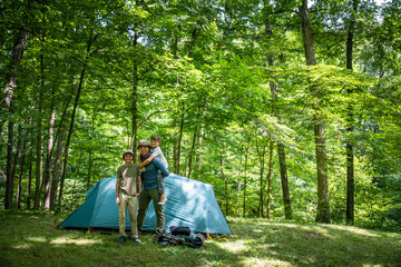 Air Force service member sets up a tent with his sons on  a backpacking trip. © Scott Thompson