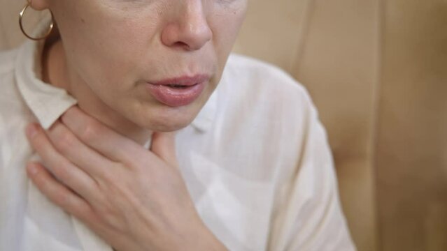 Heart attack with difficult breathing. A view of sick female with heart attack with hard breathing in the room.