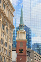 Clock Tower church with modern glass building on the background in Boston, USA
