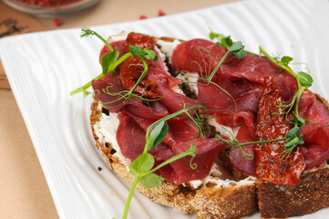 bruschetta with veal in a white plate, macro photo
