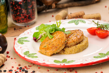 fish cutlets with porridge in a plate
