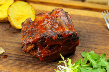 fried rib with meat on the bone in tomato sauce

