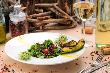 salad with quinoa porridge, tomatoes, avocado and greens in an original serving in a white plate, macro photo
